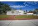 House exterior with large yard, driveway, and detached garage at 1931 Bayshore Dr, Englewood, FL 34223