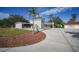Home exterior showcasing landscaping and a spacious driveway at 1931 Bayshore Dr, Englewood, FL 34223