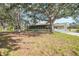 Ranch style home with screened porch and large shade trees at 1931 Bayshore Dr, Englewood, FL 34223