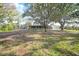 Ranch style home with screened porch and large shade trees at 1931 Bayshore Dr, Englewood, FL 34223
