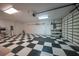 Spacious garage with checkerboard flooring and ample storage at 1931 Bayshore Dr, Englewood, FL 34223