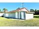 Detached garage with multiple doors and red tile roof at 1931 Bayshore Dr, Englewood, FL 34223