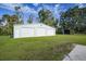 Triple-wide garage with additional storage shed at 1931 Bayshore Dr, Englewood, FL 34223