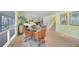 Gathering room with wicker furniture, a grand piano, and large windows at 1931 Bayshore Dr, Englewood, FL 34223