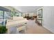 Gathering room features a grand piano, stone fireplace, and ample seating at 1931 Bayshore Dr, Englewood, FL 34223