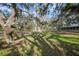 White gazebo with red tile roof in a shaded backyard setting at 1931 Bayshore Dr, Englewood, FL 34223