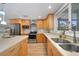 Modern kitchen with stainless steel appliances and light wood cabinets at 1931 Bayshore Dr, Englewood, FL 34223
