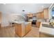 Spacious kitchen with island, stainless steel appliances, and light wood cabinets at 1931 Bayshore Dr, Englewood, FL 34223