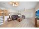 Living room with a brown leather couch, coffee table, and large windows at 1931 Bayshore Dr, Englewood, FL 34223