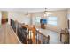 Spacious loft area with wood flooring, ceiling fans, and a large TV at 1931 Bayshore Dr, Englewood, FL 34223