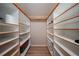 Large walk-in pantry with ample shelving for storage at 1931 Bayshore Dr, Englewood, FL 34223