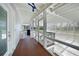 Screened porch with wood flooring and access to backyard at 1931 Bayshore Dr, Englewood, FL 34223