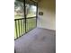 Screened lanai with carpet and view of green space at 19505 Quesada Ave # B203, Port Charlotte, FL 33948