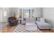 Bright living room featuring a sectional sofa, ottoman, and wood floors at 22561 Blanchard Ave, Port Charlotte, FL 33952