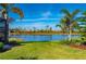 Lakefront backyard with lush landscaping and privacy at 2427 Daisy Dr, North Port, FL 34289