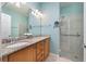 Double vanity bathroom with granite countertops and a large walk-in shower at 2427 Daisy Dr, North Port, FL 34289