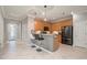 Modern kitchen with wood cabinets, granite counters, and stainless steel appliances at 2427 Daisy Dr, North Port, FL 34289