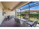 Spacious screened-in porch with seating area and ceiling fan at 2427 Daisy Dr, North Port, FL 34289