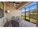 Relaxing screened porch, outdoor seating, ceiling fan at 2427 Daisy Dr, North Port, FL 34289