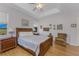 Main bedroom with wooden bed frame and natural light from large windows at 24490 Wallaby Ln, Punta Gorda, FL 33955