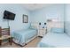 Guest bedroom with twin beds and a flat-screen TV at 24490 Wallaby Ln, Punta Gorda, FL 33955