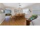 Spacious dining room with hardwood floors, a large table, and plenty of natural light at 24490 Wallaby Ln, Punta Gorda, FL 33955