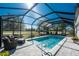 Inviting screened pool with patio furniture and lush landscaping at 24490 Wallaby Ln, Punta Gorda, FL 33955