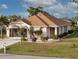 Charming single-story home with a well-maintained lawn, landscaping, and a screened-in garage at 25554 Prada Dr, Punta Gorda, FL 33955