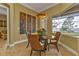 Breakfast nook features a glass table and wicker chairs with water views at 2863 Mill Creek Rd, Port Charlotte, FL 33953