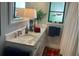 Bathroom featuring vanity with granite countertops and decorative lamp and towels at 3202 Meadow Run Dr, Venice, FL 34293