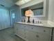 Bathroom with dual sinks, granite countertops, and large vanity mirror at 3202 Meadow Run Dr, Venice, FL 34293