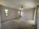 Spacious carpeted bedroom with a ceiling fan and two bright windows at 3202 Meadow Run Dr, Venice, FL 34293