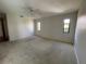 Large bedroom featuring neutral carpet, bright windows, and a ceiling fan at 3202 Meadow Run Dr, Venice, FL 34293