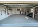 Clean garage with storage and plenty of shelving, painted with an epoxy floor at 3202 Meadow Run Dr, Venice, FL 34293