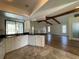 Kitchen features a large sink, black countertops, white cabinets and open view to the living room at 3202 Meadow Run Dr, Venice, FL 34293