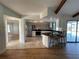 Bright kitchen features stainless appliances, tiled floors, a breakfast bar and access to the pool area at 3202 Meadow Run Dr, Venice, FL 34293