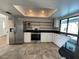 Modern kitchen featuring stainless steel appliances, granite countertops, and open shelving at 3202 Meadow Run Dr, Venice, FL 34293