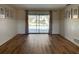 Bright living room with wood floors and sliding doors leading to the pool area at 3202 Meadow Run Dr, Venice, FL 34293