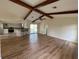 Living room with vaulted ceiling, exposed beams, kitchen and pool views at 3202 Meadow Run Dr, Venice, FL 34293