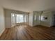 Bright living room featuring wood floors, large windows, and neutral paint at 3202 Meadow Run Dr, Venice, FL 34293