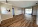 Spacious living room with wood floors and a view of the pool through sliding glass doors at 3202 Meadow Run Dr, Venice, FL 34293