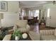 Cozy living room featuring two armchairs, and view of the dining room and the entry door at 3202 Meadow Run Dr, Venice, FL 34293