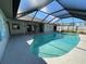 Inviting screened-in pool with a sun-drenched deck, ideal for relaxing and enjoying the outdoors at 3202 Meadow Run Dr, Venice, FL 34293