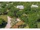 House and property overview, showcasing the driveway and surrounding nature at 3800 Acline Rd, Punta Gorda, FL 33950