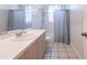Clean bathroom featuring a shower/tub combo, single sink vanity, and tile floor at 3800 Acline Rd, Punta Gorda, FL 33950