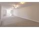 Large bonus room with neutral carpeting and multiple ceiling fans at 3800 Acline Rd, Punta Gorda, FL 33950