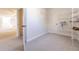 Bonus room with carpet, storage shelving, and access to other rooms at 3800 Acline Rd, Punta Gorda, FL 33950