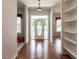Bright entryway with hardwood floors, built in shelving, and an oval door at 3800 Acline Rd, Punta Gorda, FL 33950