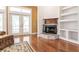 Stone fireplace with wooden mantle in a bright living room at 3800 Acline Rd, Punta Gorda, FL 33950