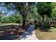 Landscaped garden path with lush foliage at 3800 Acline Rd, Punta Gorda, FL 33950